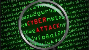 A magnifying glass over characters on a computer screen, illustrating a cyberattack.